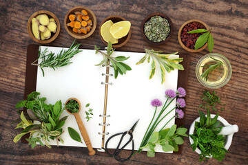 Fototapeta na wymiar Spice and herb collection. Fresh food home grown local produce seasoning with open recipe notebook and mortar. Herbs also used in herbal plant medicine. On rustic wood. Top view, flay lay.