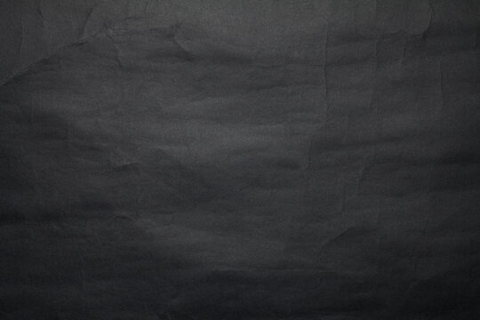 Black paper texture background. Close-up.