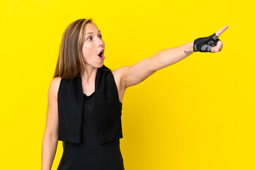 Young sport English woman isolated on white background pointing away