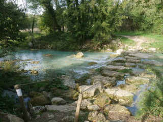 walkway with stones in the river bed that allow you to cross it from one bank to the other in...