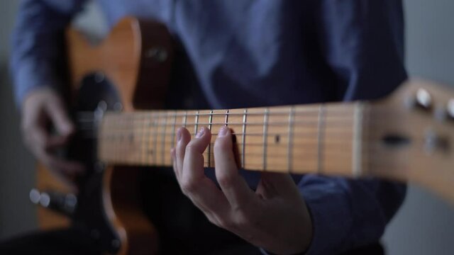Musician at home with live instrument, guitar sample pack for your daw. Playing solo on electric guitar, distance music learning. Concept of modern producer