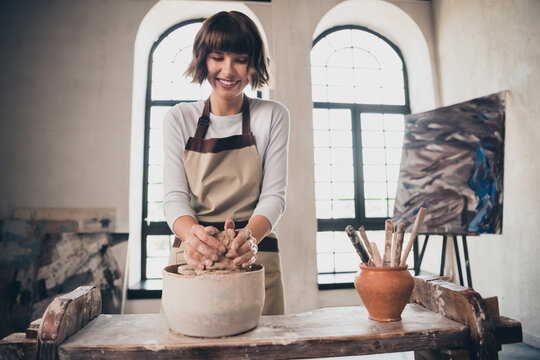 Photo of small pottery business owner lady potter teach figure wheel porcelain gift pot order in workroom