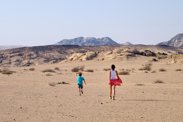 mother and son running through the desert