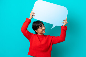Young woman isolated on blue background holding an empty speech bubble