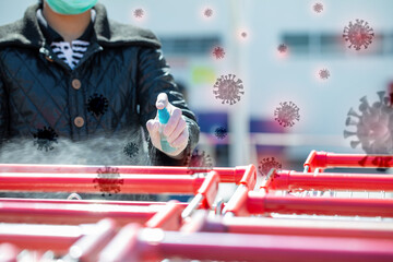 People use alcohol to spray the handles of shopping carts to prevent the spread of the covid 19...