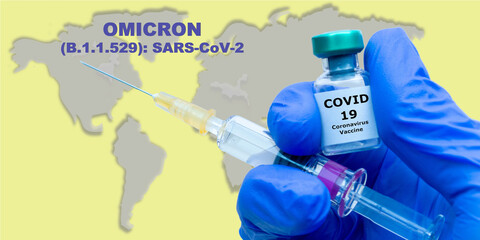 OMICRON (B.1.1.529): SARS-CoV-2. Coronavirus, Covid 19 Virus Syringe, vaccine vial in human hand...