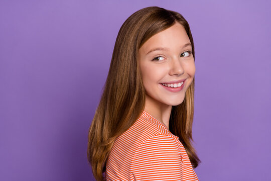 Profile side view portrait of attractive cheerful curious girl looking aside copy space isolated over bright violet purple color background