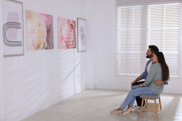 Lovely couple at exhibition in art gallery