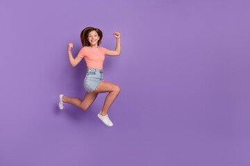 Fototapeta na wymiar Full length body size view of lovely cheery trendy girl jumping showing strength running isolated on bright violet purple color background