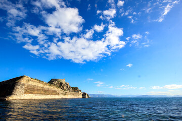 	
Corfu Castle old fort Greek island surrounded by blue sea sky and mountains a tourist attraction in Mediterranean Greece.	
