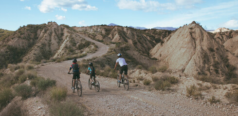 Fototapeta na wymiar family biking in wilderness countryside landscape