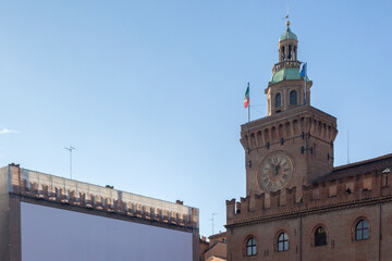 Fototapeta na wymiar The tower of Palazzo D’Accursio or Comunale, located in Piazza Maggiore, is one of the most important buildings in Bologna and the seat of the Municipality of the city. 