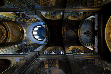 Dark distant ornate ceiling of Volodymyr's Cathedral in Kyiv Ukraine