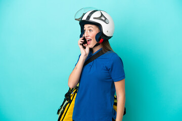 Young caucasian woman with thermal backpack isolated on white background keeping a conversation with the mobile phone