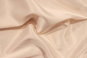 Silk atlas soft tender beige color fabric with shiny waves macro