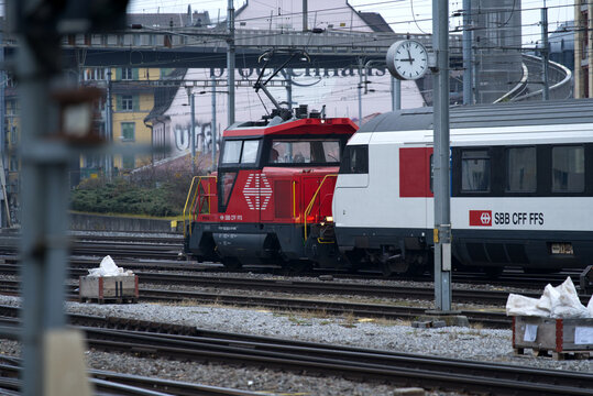 Track field with with red SBB shunting train at Zürich main railway station on a foggy winter morning. Photo taken December 15th, 2021, Zurich, Switzerland.