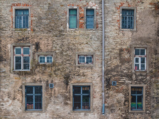 Several windows on facade of the urban historic building front view, Tallinn, Estonia
