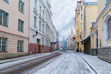 Fototapeta na wymiar Perspective view of old buildings on the Pikk Street in overcast winter day, Tallinn Old Town, Estonia 