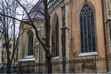 The yard, the fence and the facade of the Saint Olaf's Church in overcast winter day, Tallinn Old...