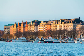 Beautiful view of boats on the Riddarfjarden Bay and the historic building on the shore of the...