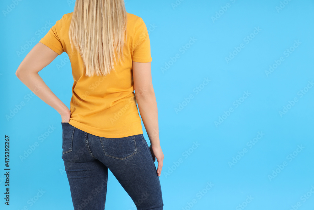 Poster Woman in blank orange t-shirt on blue background