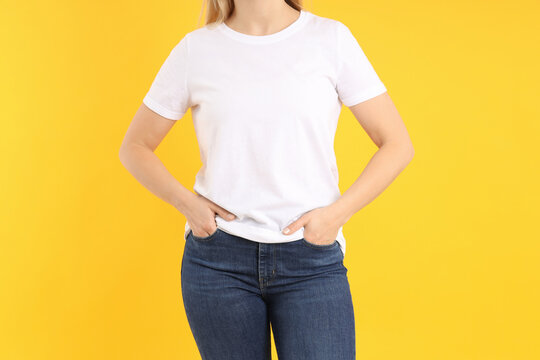 Woman in blank white t-shirt on yellow background