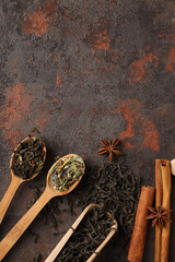 Concept of cooking tea with different types of tea on dark textured background