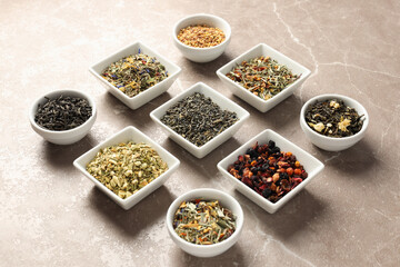 Flat lay with different types of tea on textured background