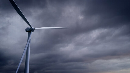 ecologic windmill on heavy clouds backdrop, fictional design - industrial 3D illustration