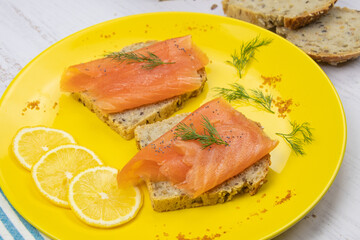 smoked salmon toast on yellow plate