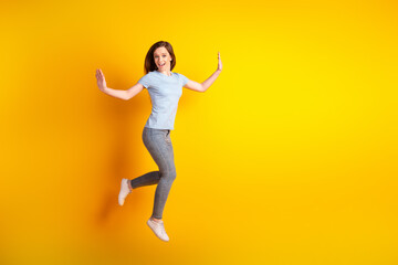 Fototapeta na wymiar Full size profile side photo of young cheerful girl walk run have fun jumper isolated over yellow color background