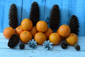 Fresh pink tangerines  for Christmas decorated with fir cones