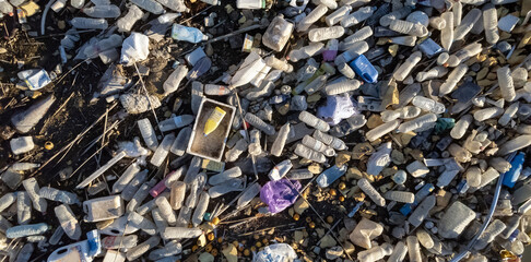 Aerial shot, scrap-heap pile of plastic rubbish. Top view lot bottles, pollution debris outdoors. Global damage, environmental pollution concept. Costa Blanca. Guardamar del Segura. Spain