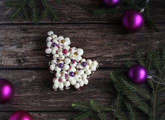 festive beautiful cake in the form of a spruce on a wooden background with spruce branches