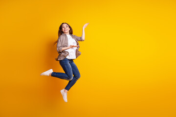 Full body profile side photo of young girl demonstrate product offer advertise isolated over yellow color background