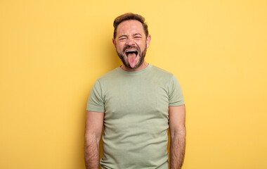 middle age handsome man with cheerful, carefree, rebellious attitude, joking and sticking tongue...