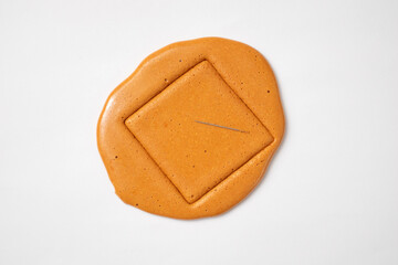 Korean Dalgona sugar candy cookie with a metal needle