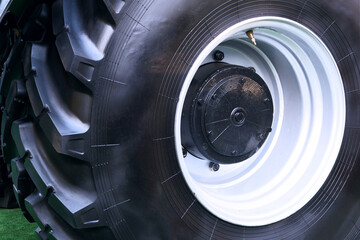 Tractor wheel protector, close up. Agronomy, farming, husbandry concept. Wheels of modern transport.