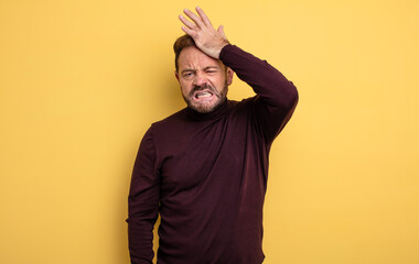 middle age handsome man panicking over a forgotten deadline, feeling stressed, having to cover up a mess or mistake