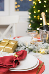 Christmas festive table setting, red towel with gold ring. Family holiday dinner or night New Year party. Vertical format. Close up.