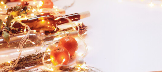 Bottles of wine, mandarins, pine, garland, Christmas decoration on white background 
