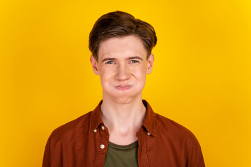 Photo of young man have fun fool hold breath pouted cheeks comic isolated over yellow color...