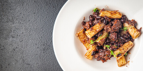 rigatoni pasta beans sauce healthy meal food diet snack on the table copy space food background rustic. top view veggie vegan or vegetarian food no meat