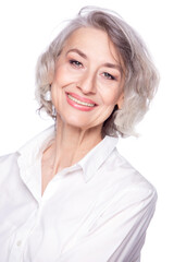 Close up portrait of pleasant grey-haired middle aged female looking at camera with a wide smile and showing happiness, isolated on white studio background