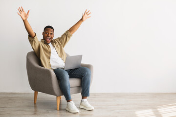 Black Man With Laptop Raising Hands In Joy, Gray Background