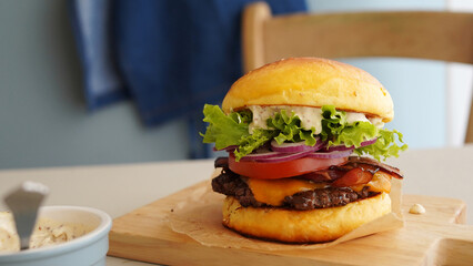 burger on a wooden board
