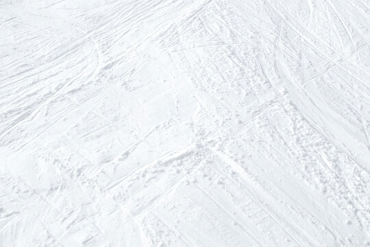 Top View Of White Ski Tracks On Snow Background.