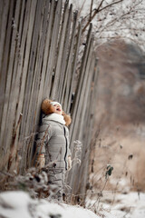 ittle girl in warm winter clothes in winter snowy forest on a walk catches snowflakes, eats snow. a child walks on the street on a winter day. snowfall, snow-covered trees, cold weather, hypothermia