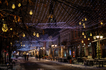 Christmas and New Year holiday lights and decorations on the streets of a European city.