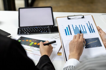 Executives and accountants are holding company financial statements and discussing them together, accountants are discussing corporate finance meetings to management. Financial concept.